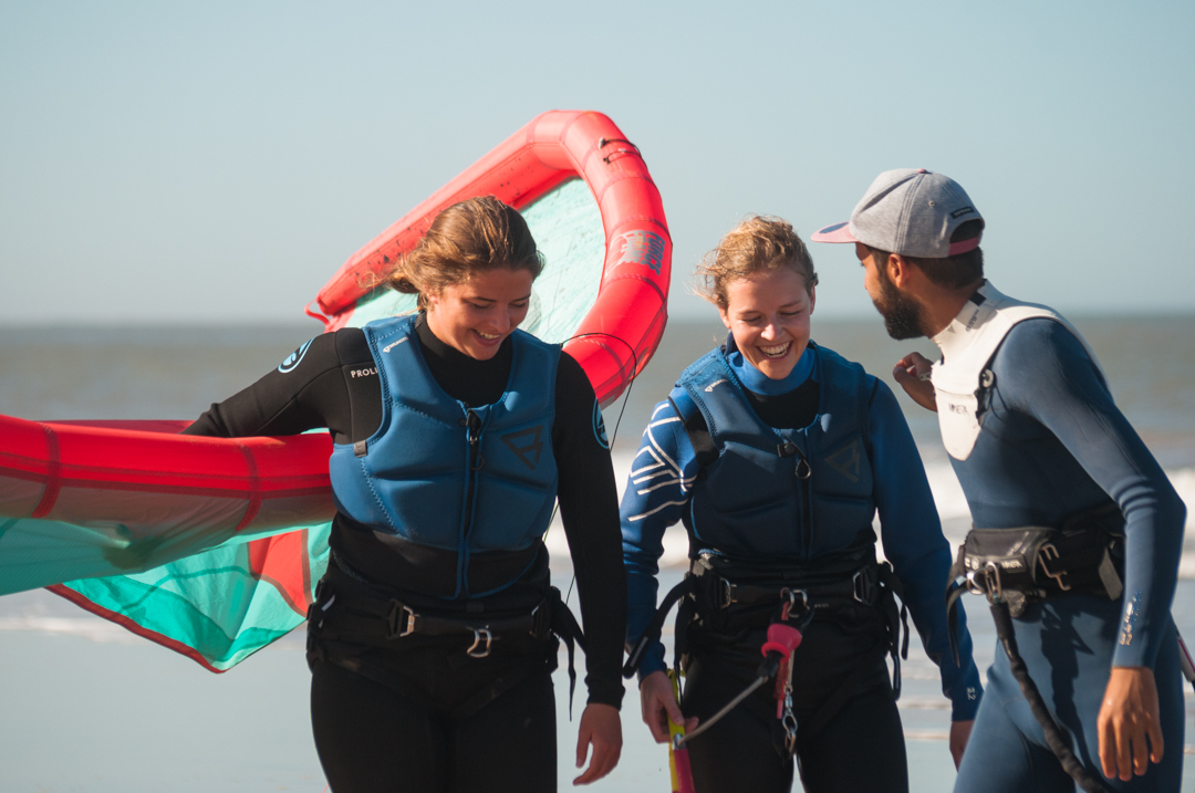 happy kitesurfer after kite lesson with instructor on the beach